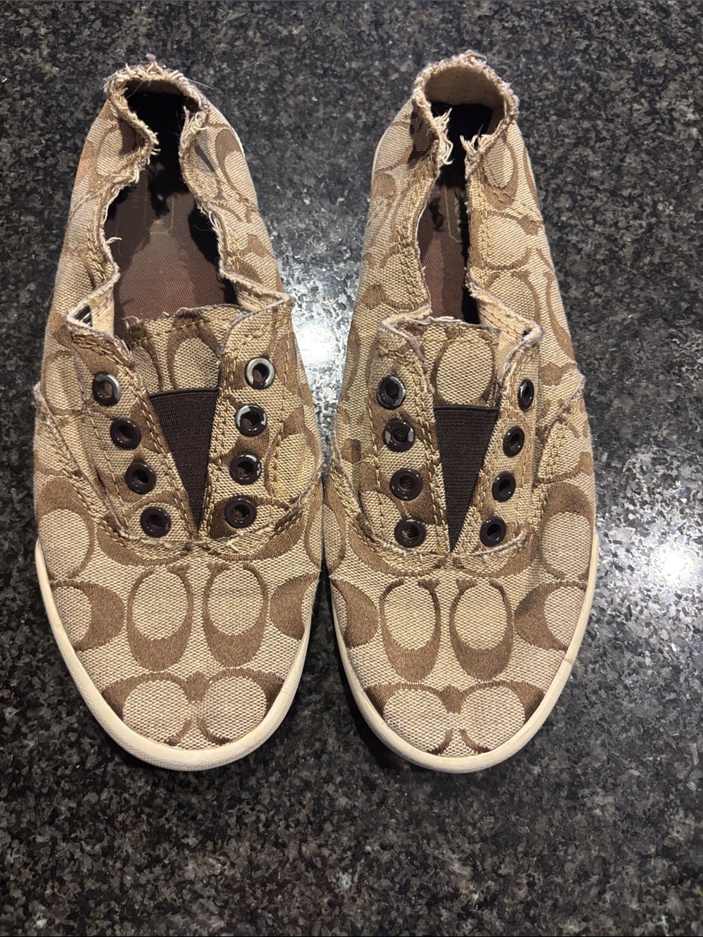 Women’s Coach Slip-On Sneakers in Tan with Signature Pattern.